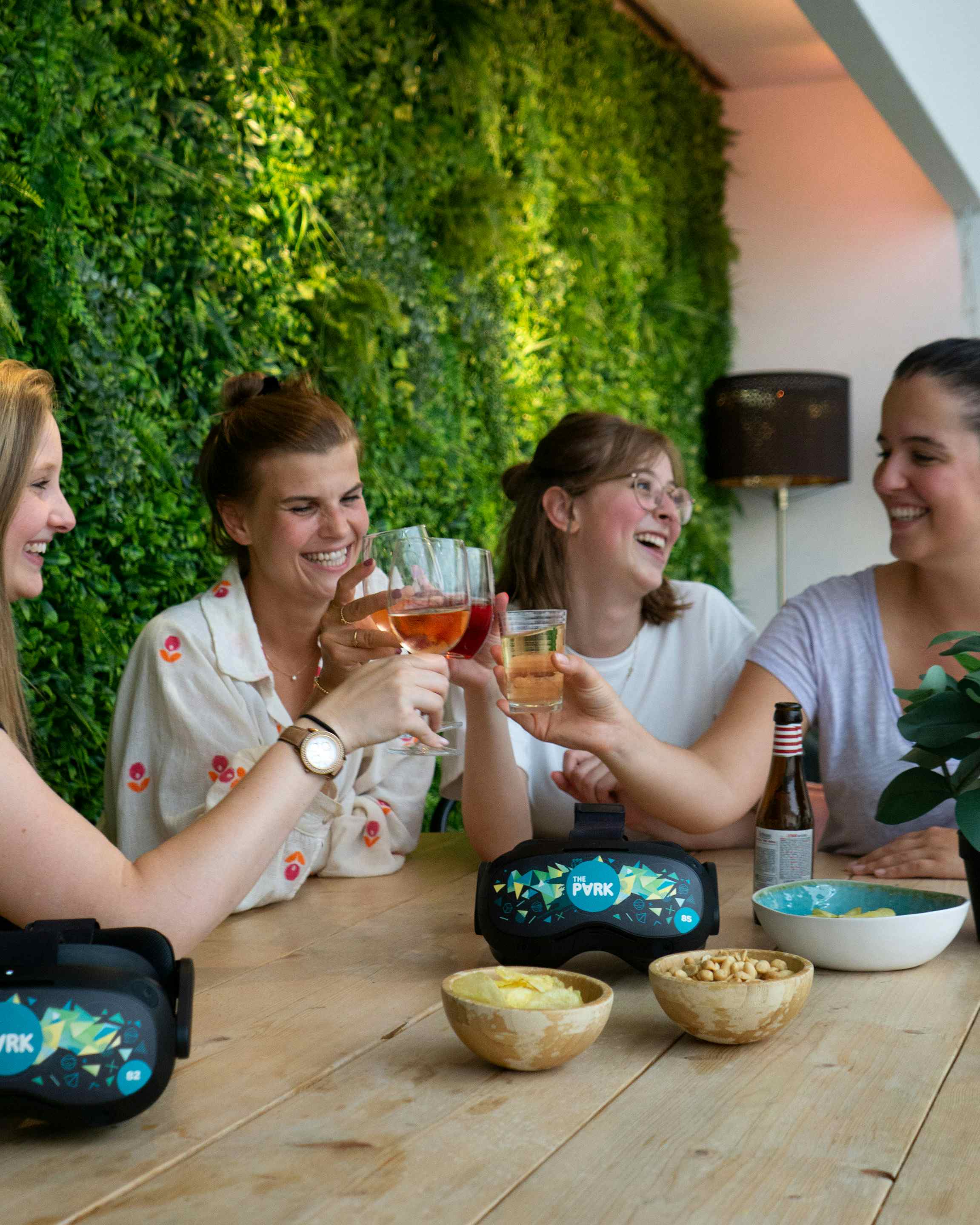 Group of women toasting glasses while laughing
